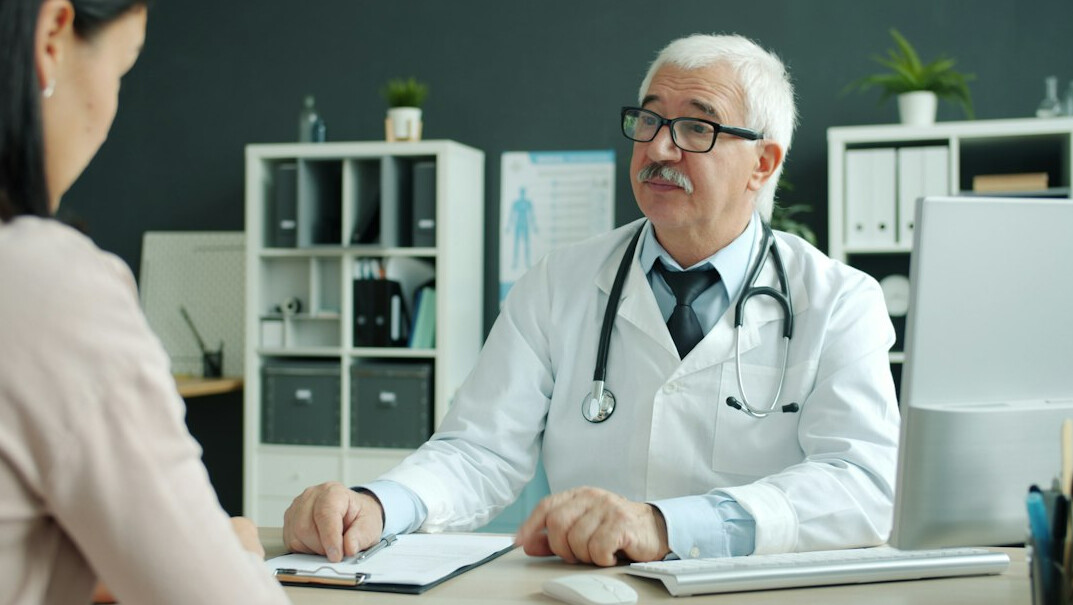 elderly couple consulting doctor